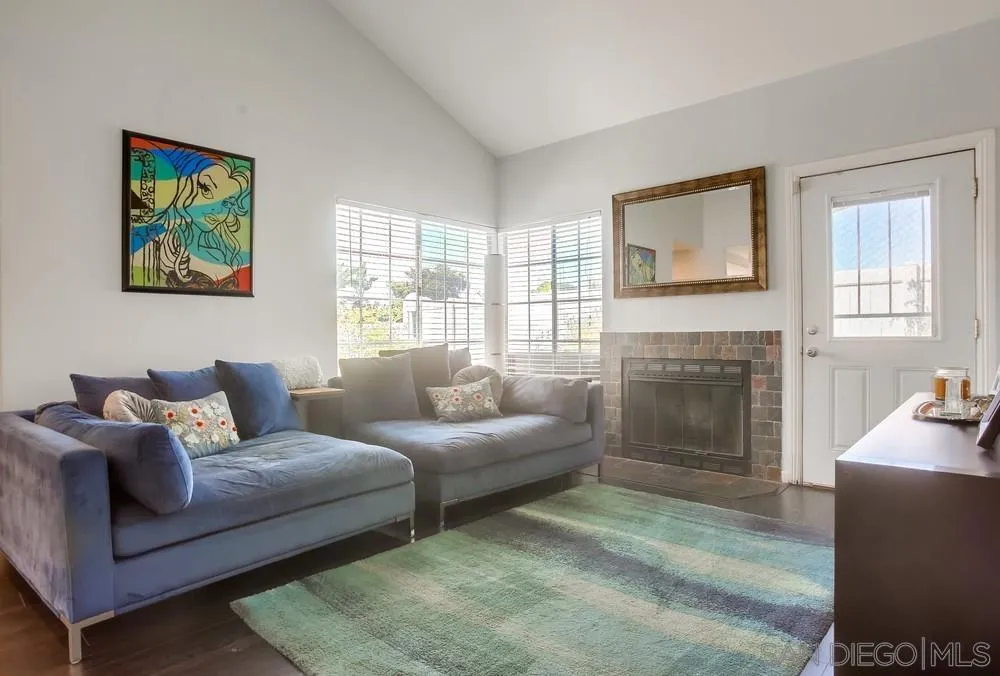 344 Riverview Way Oceanside, CA 92057 - Photo 5 of 41 a living room with furniture a large window and a fireplace