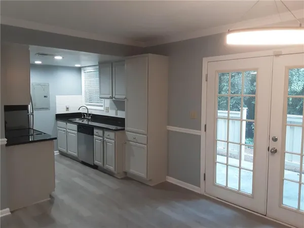 a kitchen with a sink stove and cabinets