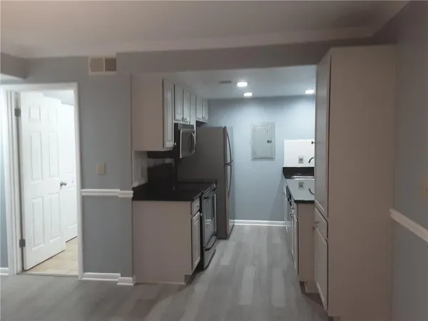 a kitchen with a refrigerator and a sink