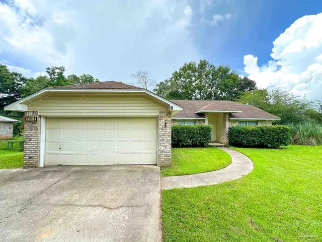 a view of a house with a yard and garage