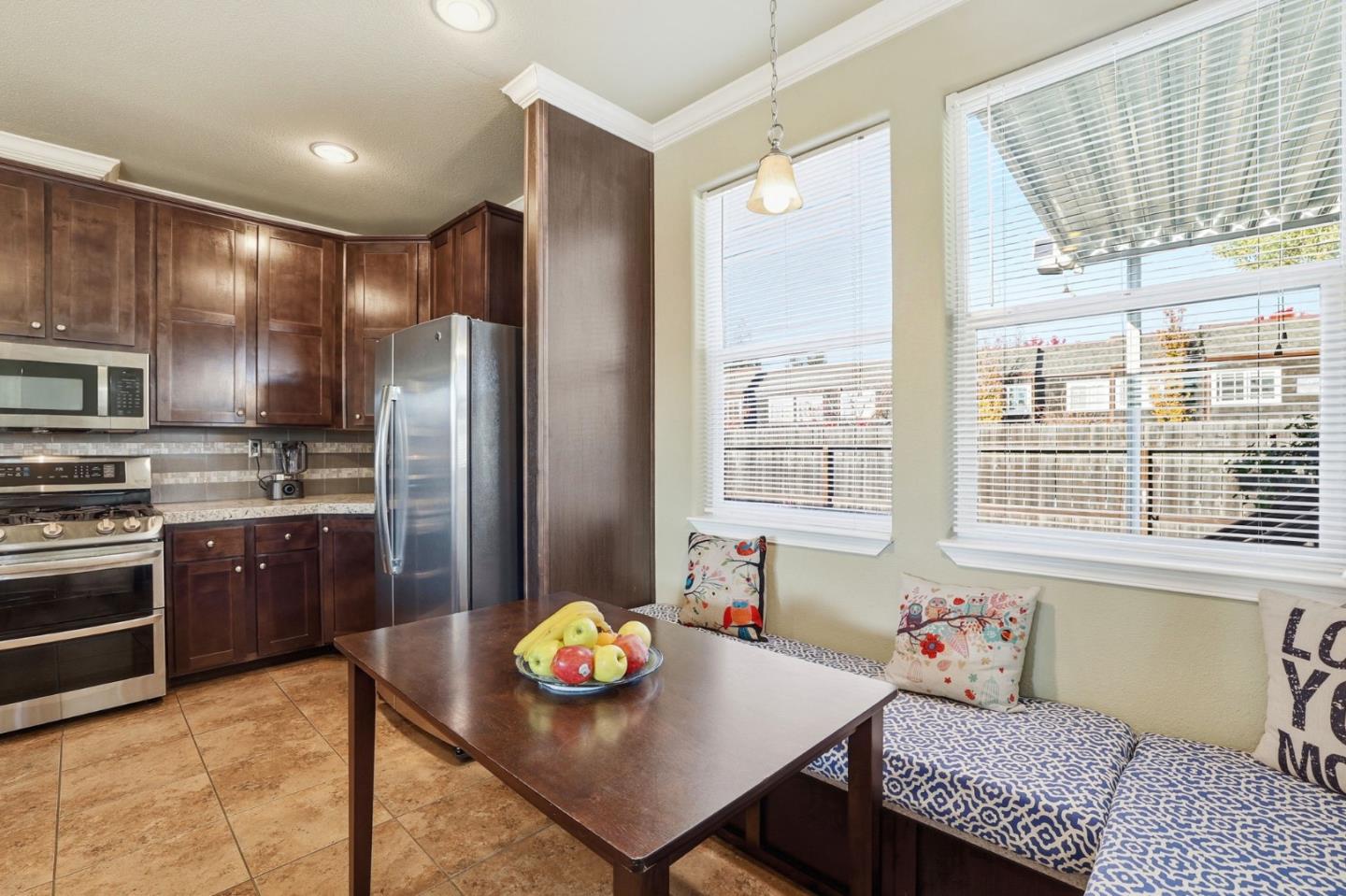 125 North Mary Avenue, Unit 17 Sunnyvale, CA 94086 - Photo 14 of 46 a kitchen with stainless steel appliances a dining table and chairs