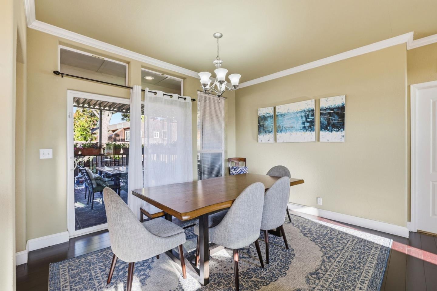 125 North Mary Avenue, Unit 17 Sunnyvale, CA 94086 - Photo 15 of 46 a dining room with furniture a chandelier and wooden floor