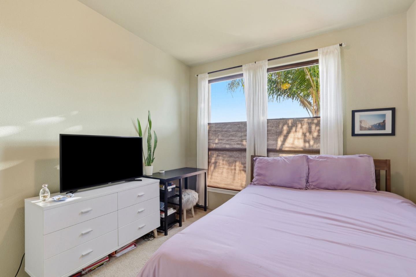 125 North Mary Avenue, Unit 17 Sunnyvale, CA 94086 - Photo 23 of 46 a bedroom with a bed and a flat screen tv