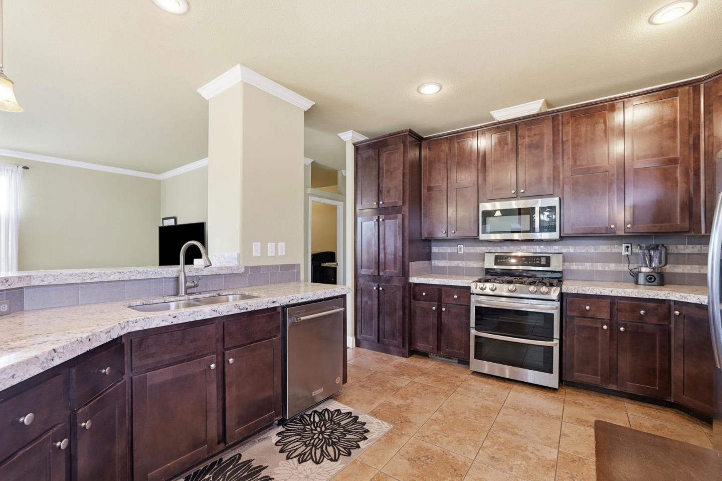 125 North Mary Avenue, Unit 17 Sunnyvale, CA 94086 - Photo 9 of 46 a kitchen with stainless steel appliances granite countertop a sink stove and refrigerator