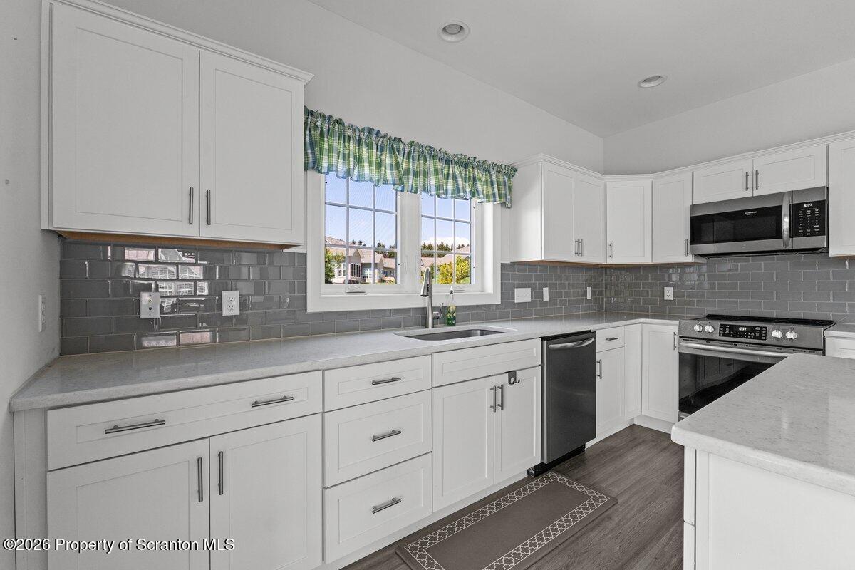15 Avalon Road Clarks Summit, PA 18411 - Photo 6 of 45 a kitchen with white cabinets and a stove top oven