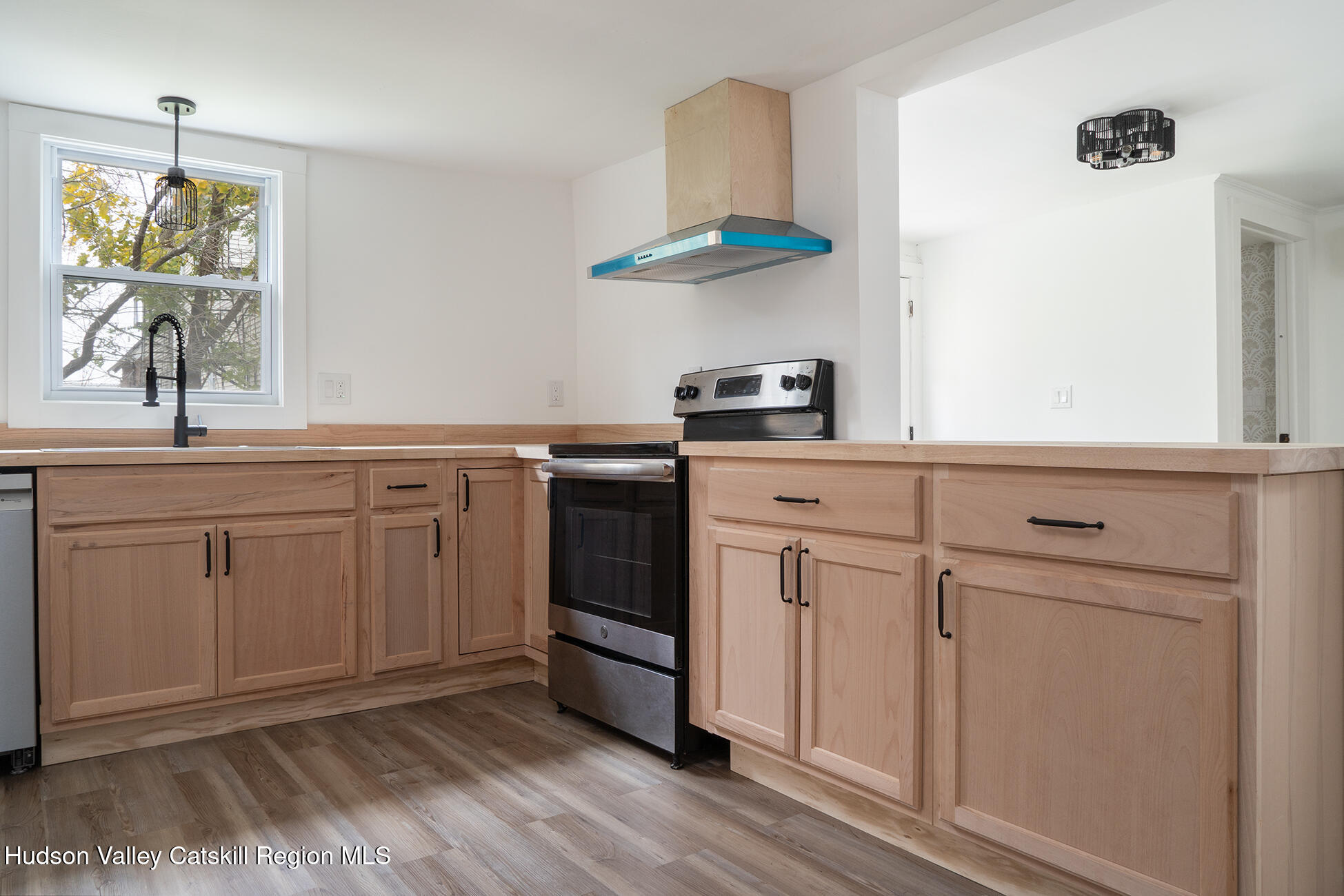 128 Broad Street Catskill, NY 12414 - Photo 8 of 15 a kitchen with white cabinets and white appliances
