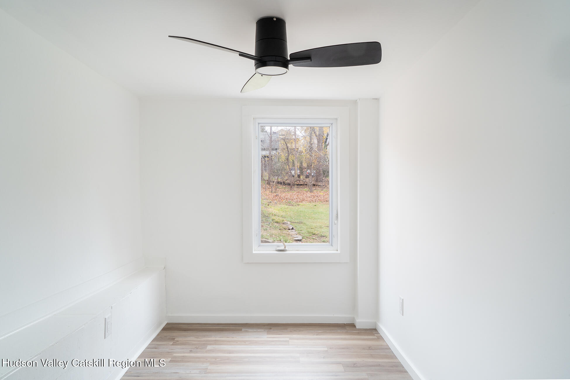 128 Broad Street Catskill, NY 12414 - Photo 9 of 15 a view of an empty room with wooden floor and a window