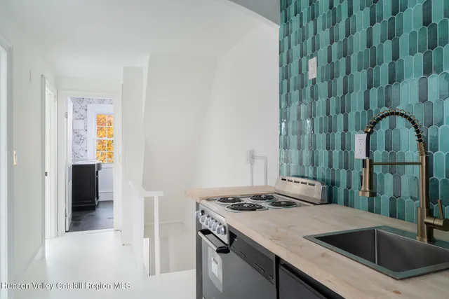 a kitchen with a sink a stove and refrigerator