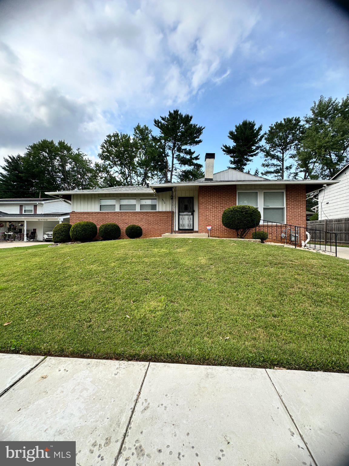 8336 Scotts Level Road Baltimore, MD 21208 - Photo 1 of 55 Charming brick home with lush greenery.