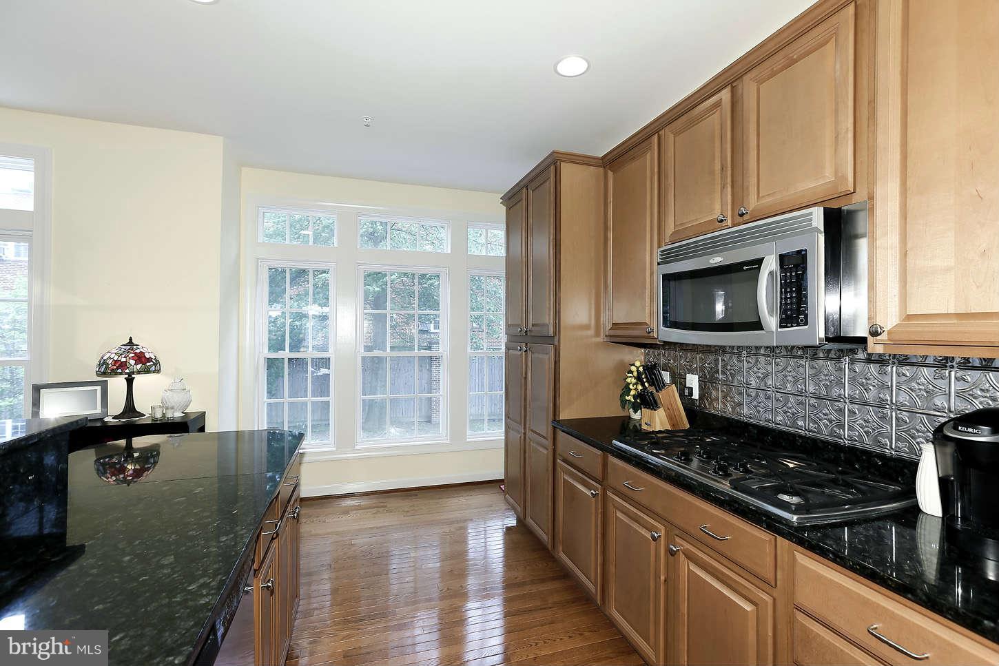 908 West Glebe Road Alexandria, VA 22305 - Photo 15 of 29 a kitchen with stainless steel appliances granite countertop a sink stove and cabinets