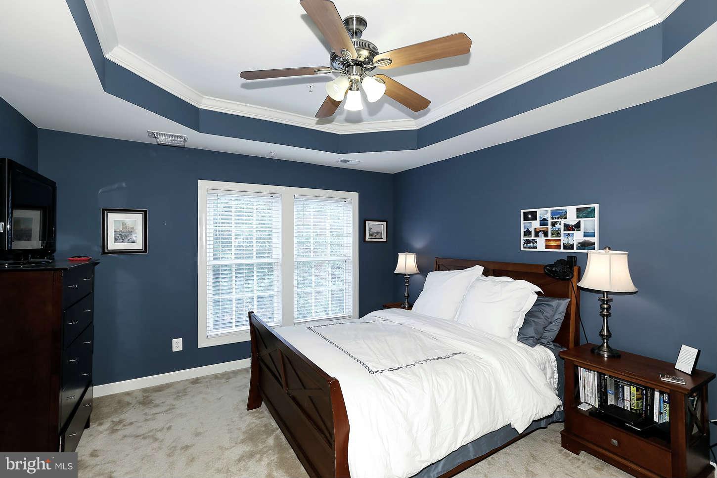 908 West Glebe Road Alexandria, VA 22305 - Photo 17 of 29 a bedroom with a bed and a chandelier