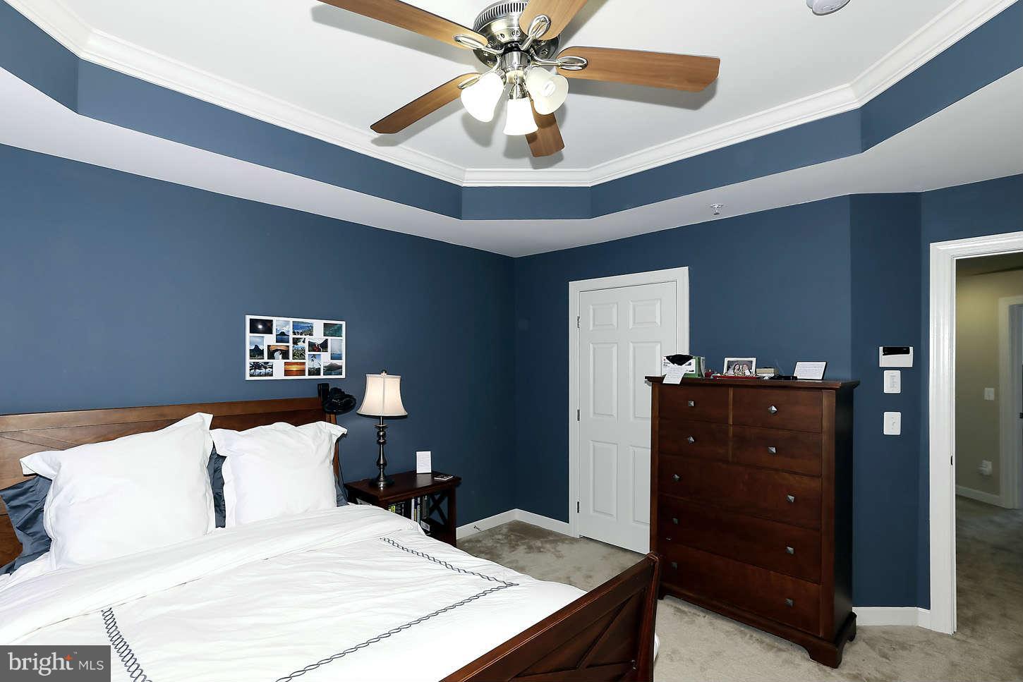 908 West Glebe Road Alexandria, VA 22305 - Photo 18 of 29 a bedroom with a bed and a chandelier