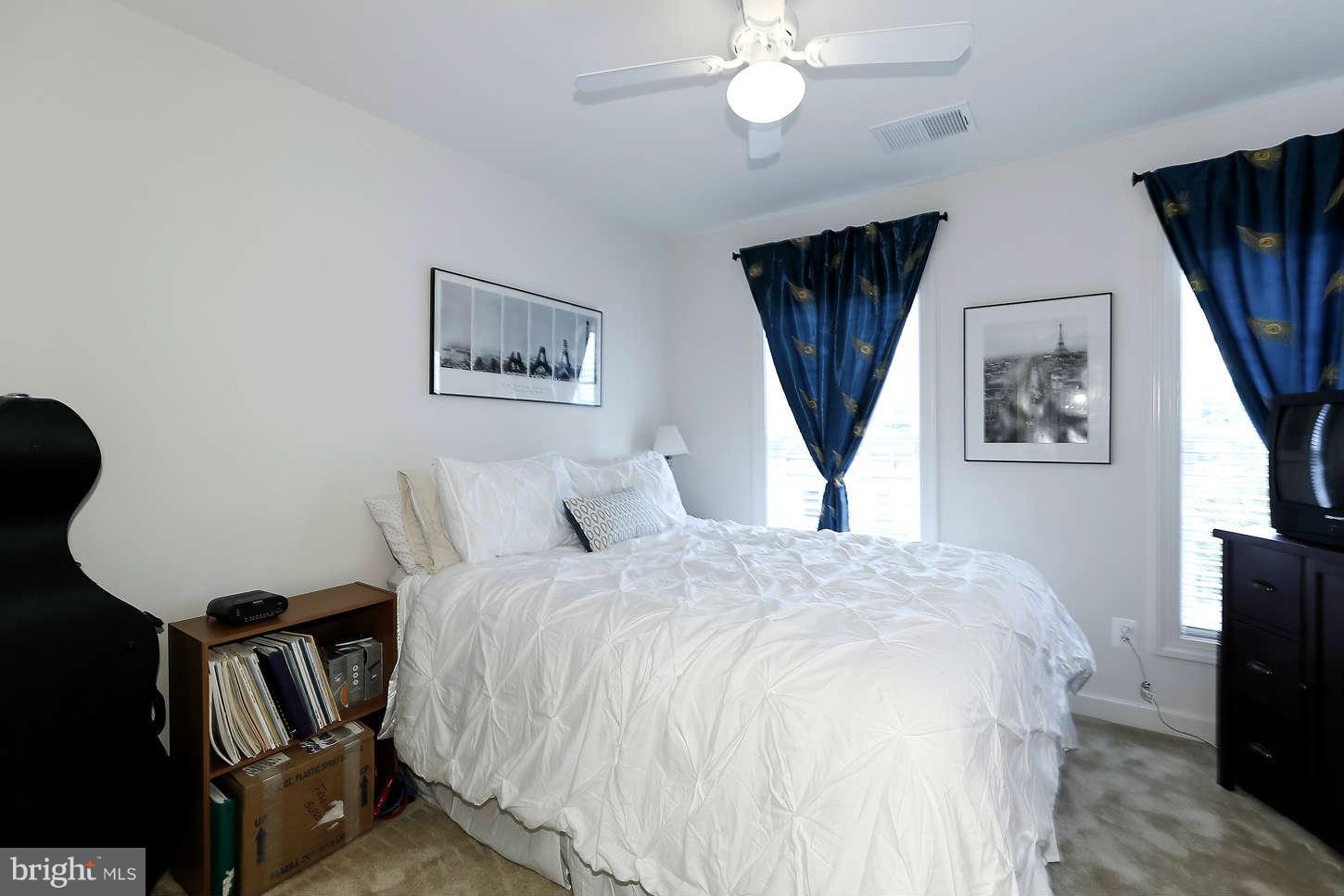 908 West Glebe Road Alexandria, VA 22305 - Photo 23 of 29 a bedroom with a bed window and a flat screen tv