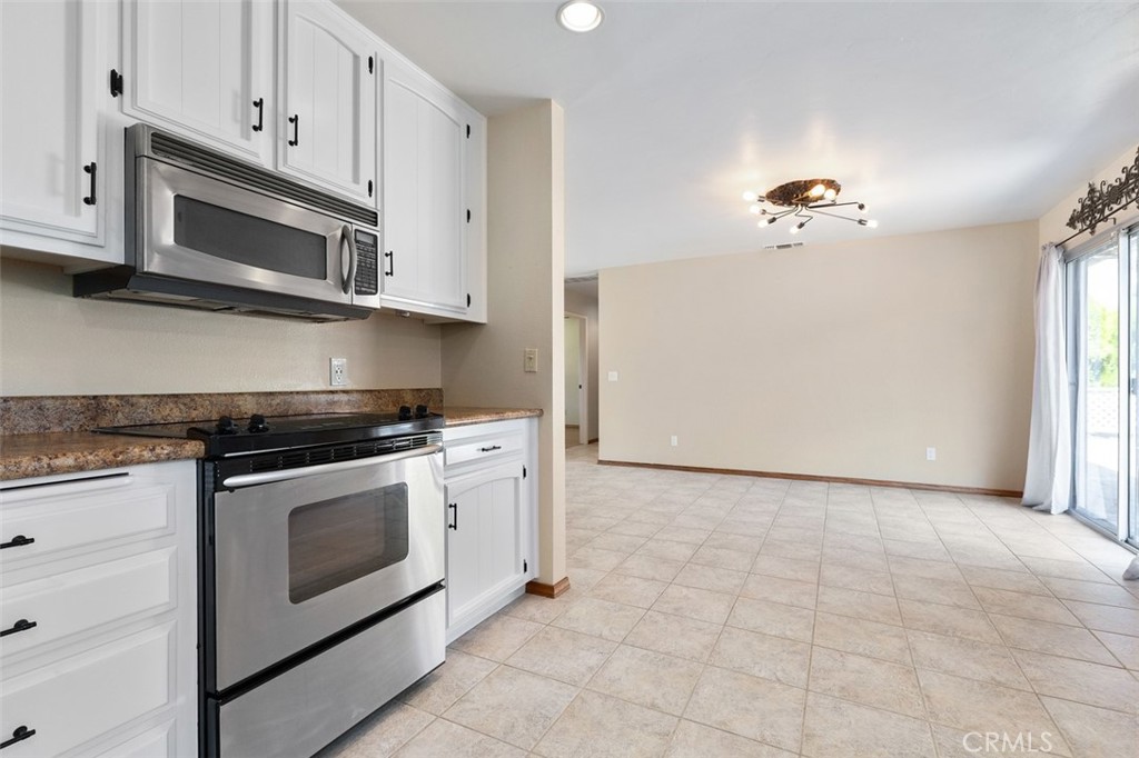 8070 Coromar Avenue Atascadero, CA 93422 - Photo 15 of 49 a stove top oven sitting inside of a kitchen