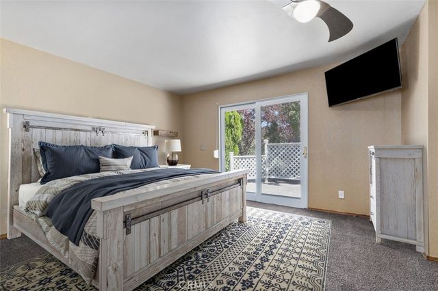 a bedroom with a large bed and a flat screen tv