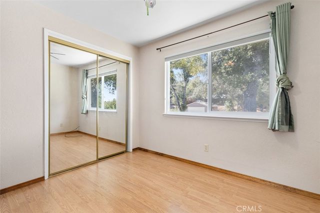 an empty room with windows and closet