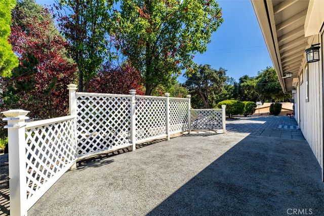 a view of a yard with wooden fence