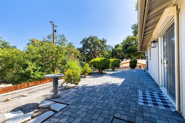 a path view of a house with a yard