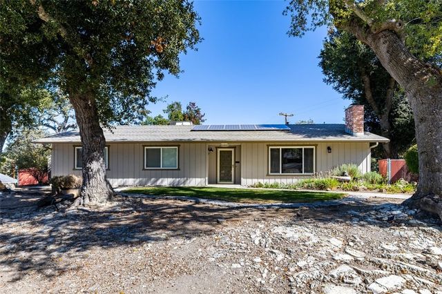 a view of the house with a yard and garage