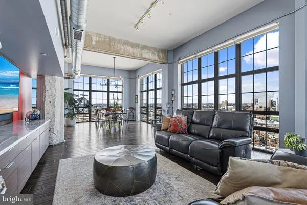 a living room with furniture and a floor to ceiling window