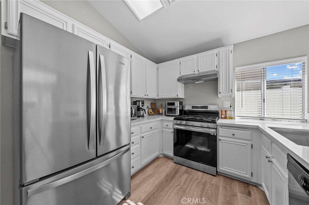 24529 Ridgewood Road Murrieta, CA 92562 - Photo 15 of 43 a kitchen with a stove sink and refrigerator