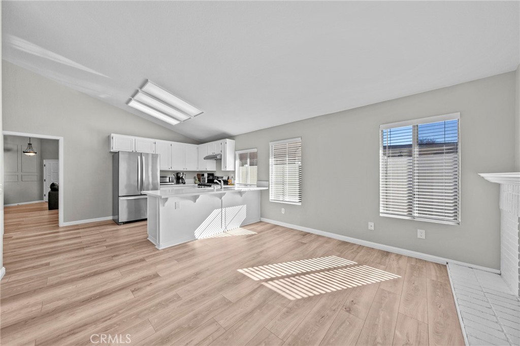 24529 Ridgewood Road Murrieta, CA 92562 - Photo 19 of 43 a view of a living room a kitchen and a wooden floor
