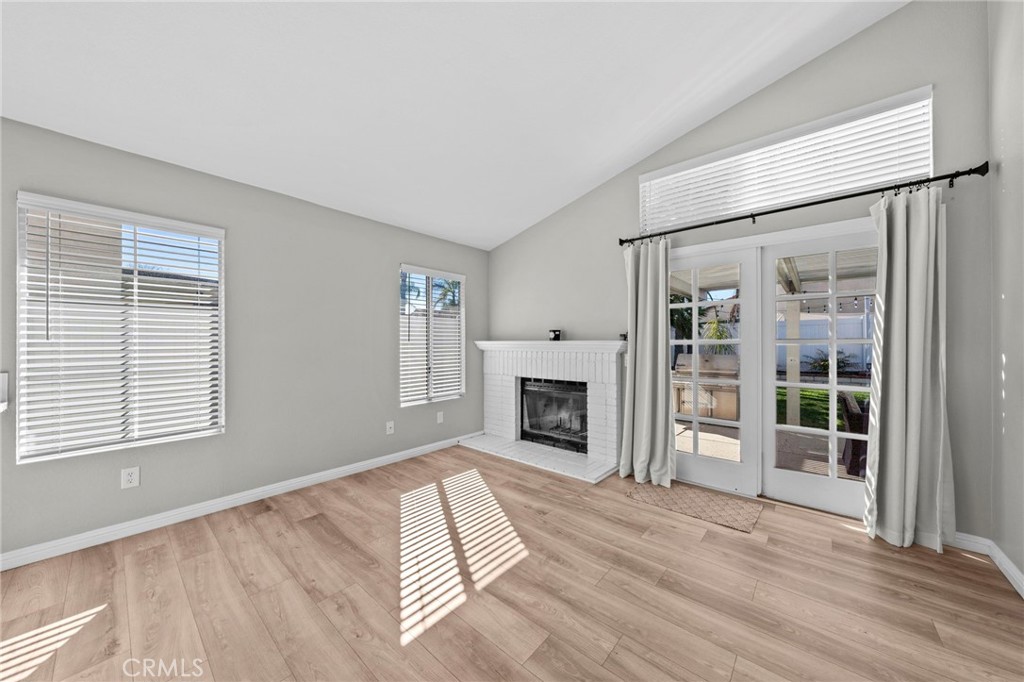 24529 Ridgewood Road Murrieta, CA 92562 - Photo 20 of 43 an empty room with fireplace wooden floor and windows