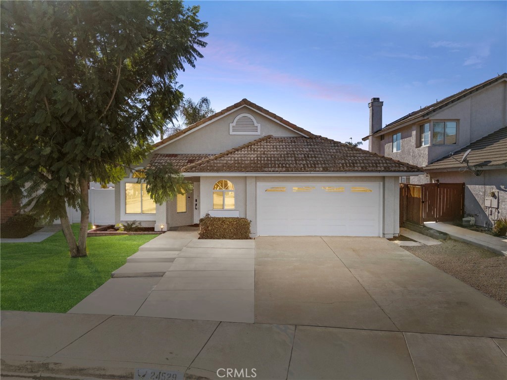 24529 Ridgewood Road Murrieta, CA 92562 - Photo 2 of 43 a view of a house with a yard and garage