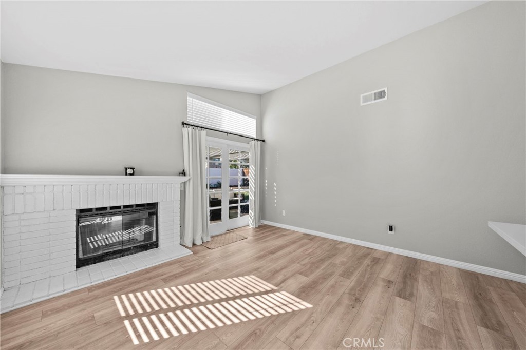 24529 Ridgewood Road Murrieta, CA 92562 - Photo 21 of 43 a view of an empty room with a fireplace and a window