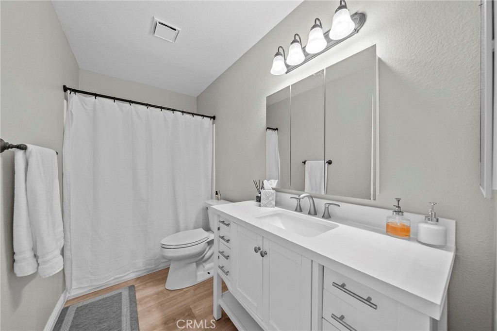 24529 Ridgewood Road Murrieta, CA 92562 - Photo 30 of 43 a bathroom with a double vanity sink mirror and toilet