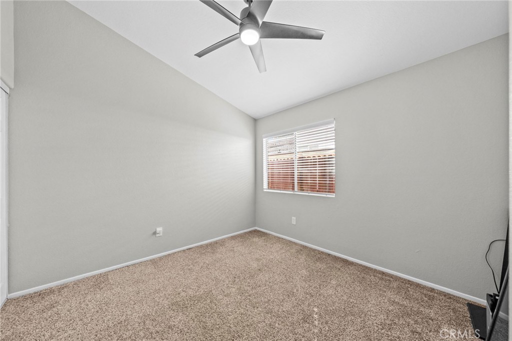 24529 Ridgewood Road Murrieta, CA 92562 - Photo 31 of 43 an empty room with a ceiling fan and a window