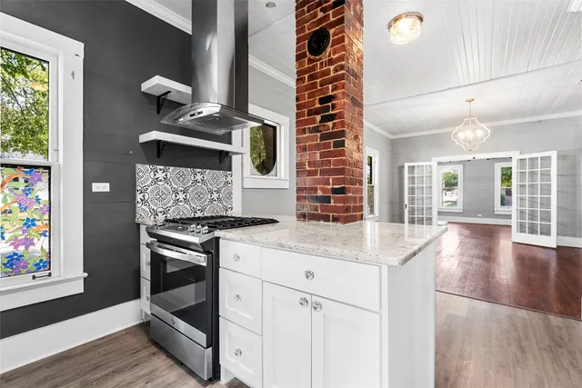 a kitchen with stainless steel appliances granite countertop a stove and a sink