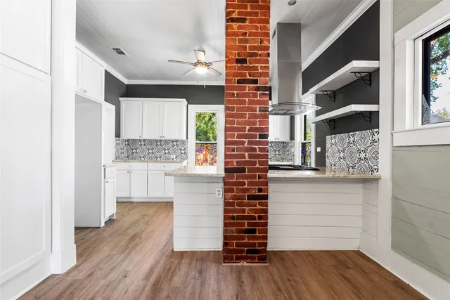 a view of walk in closet with wooden floor and cabinets