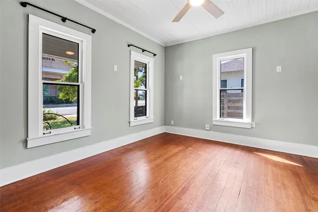 wooden floor in an empty room with a window