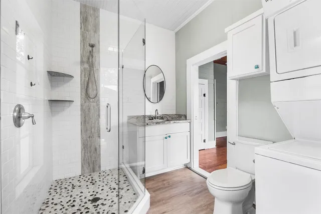 a bathroom with a sink toilet and shower