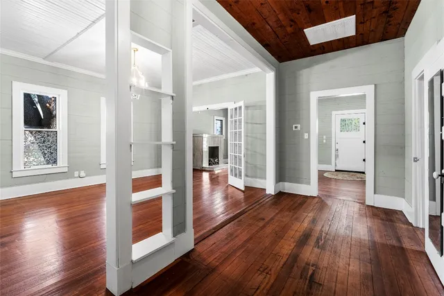a view of interior space with wooden floor and large window