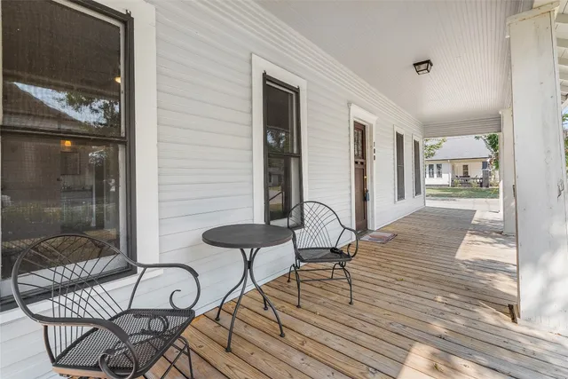 a view of a balcony and chairs and wooden floor