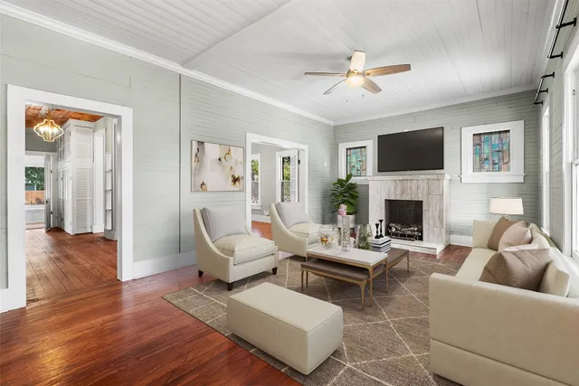 a living room with furniture a fireplace and a flat screen tv