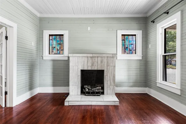 a living room with a fireplace and a wooden floor