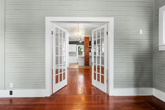 a view of a hallway with wooden floor and entryway