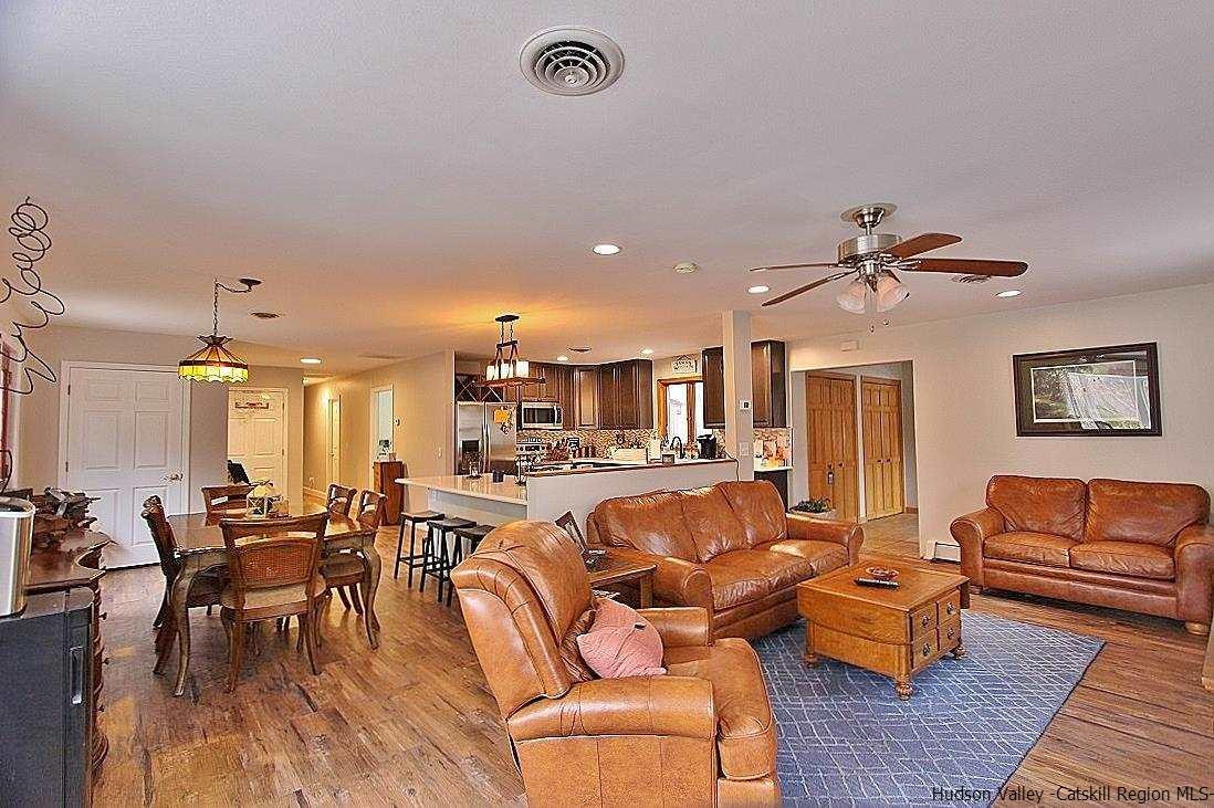 150 Nelson Hoff Road Saugerties, NY 12477 - Photo 11 of 31 a living room with furniture kitchen view and a chandelier