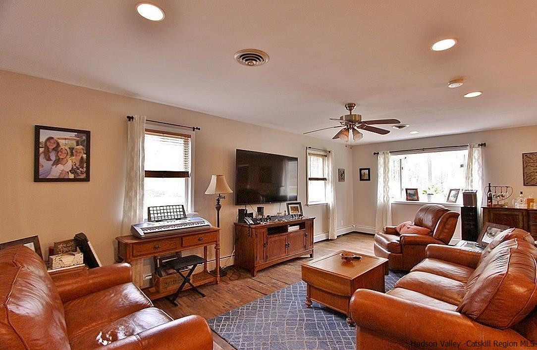 150 Nelson Hoff Road Saugerties, NY 12477 - Photo 13 of 31 a living room with furniture and a flat screen tv