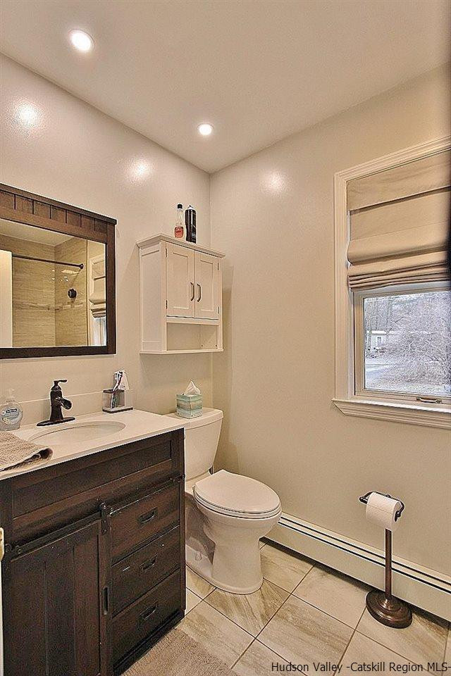 150 Nelson Hoff Road Saugerties, NY 12477 - Photo 18 of 31 a bathroom with a toilet sink double vanity and mirror