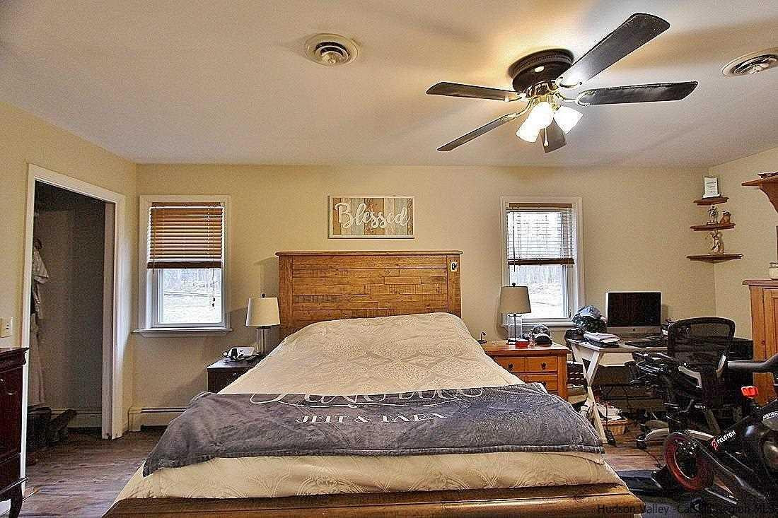 150 Nelson Hoff Road Saugerties, NY 12477 - Photo 20 of 31 a bedroom with a bed and wooden floor