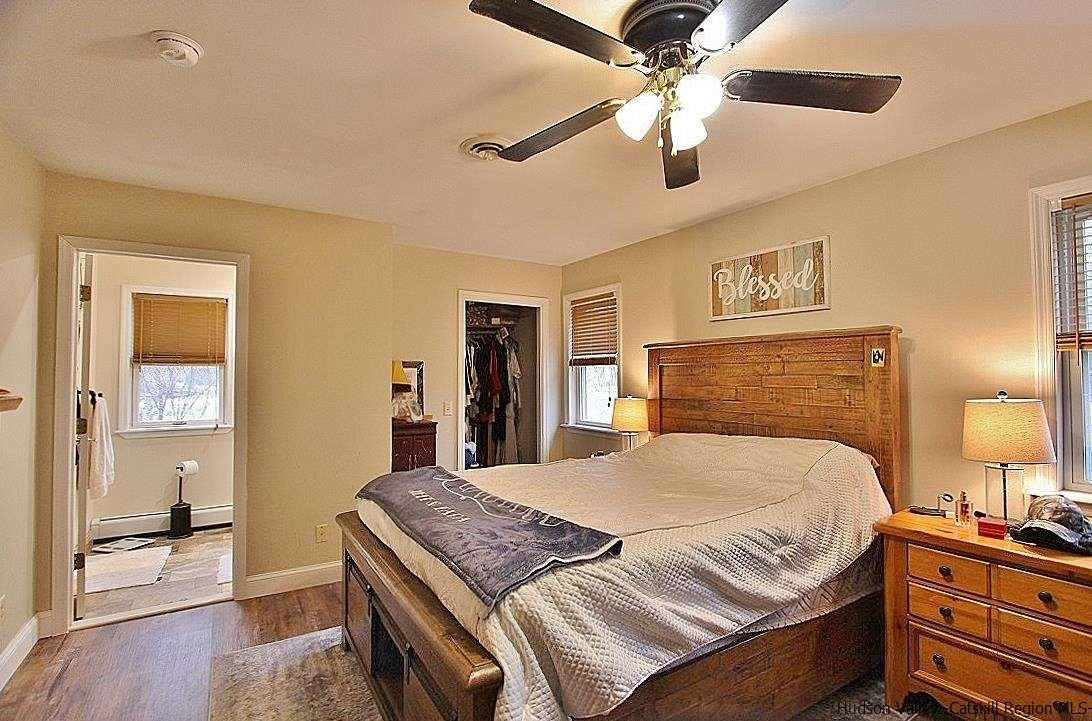 150 Nelson Hoff Road Saugerties, NY 12477 - Photo 21 of 31 a bedroom with a bed and a chandelier