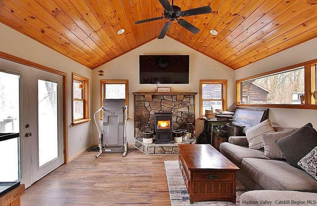 150 Nelson Hoff Road Saugerties, NY 12477 - Photo 6 of 31 a living room with furniture a flat screen tv and a fireplace