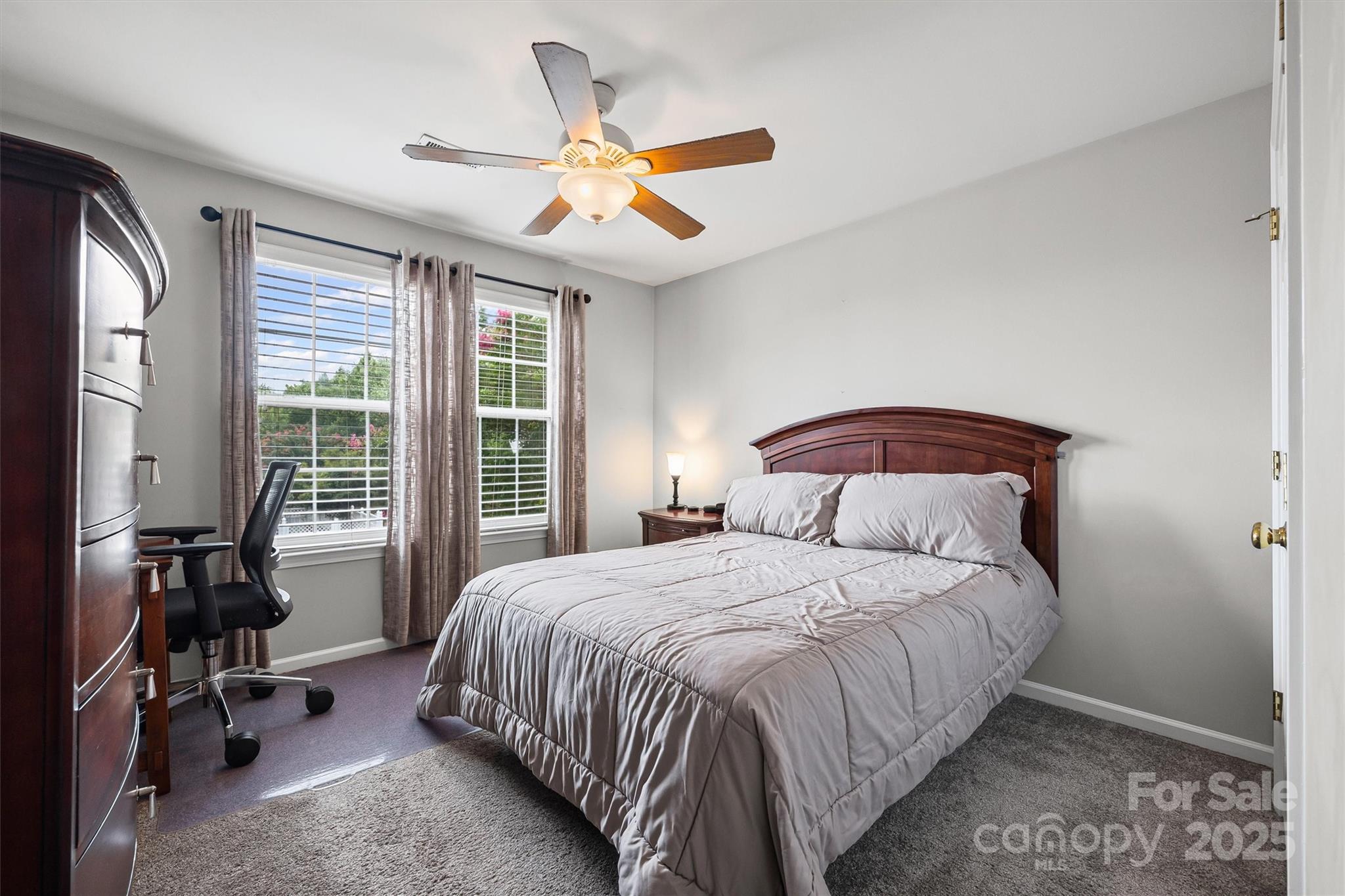 316 Tinder Box Lane Fort Mill, SC 29708 - Photo 20 of 28 a bedroom with a bed next to a window and a chandelier