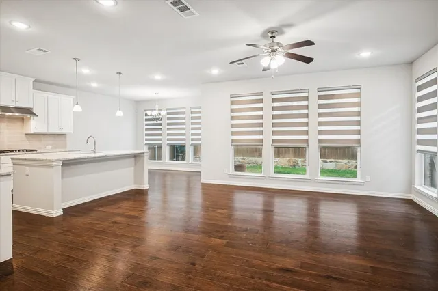a view of kitchen with wooden floor and electronic appliances