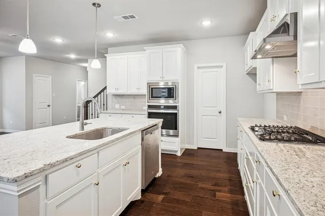 a kitchen with a sink window and cabinets