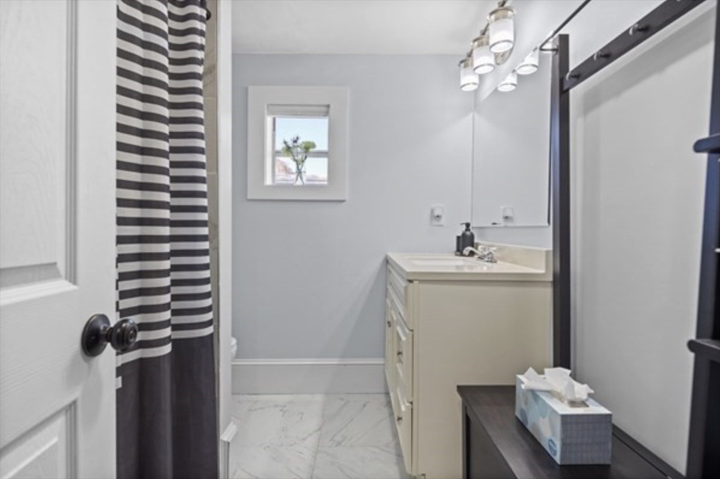 14 Everett Street, Unit 2 Medford, MA 02155 - Photo 21 of 24 a bathroom with a sink and a mirror